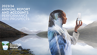 Scottish Water specialist graduate Patricia Lopes holds up glass of water against scenic mountain background