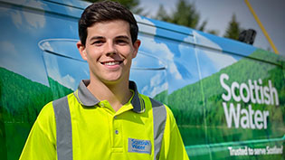 Young man standing in front of Scottish Water Van
