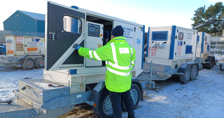 Man in hi vis jacket in front of mobile generator