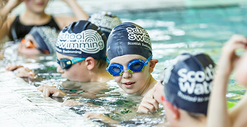 young children at poolside during a Learn to Swim lesson