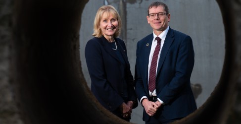 Two people posing through wide angled camera lens shot