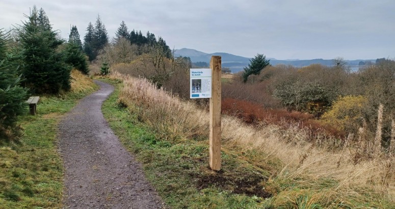 Individual sign with information and images about waterbirds at the side of a footpath at Carron Valley.